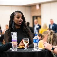 Three people standing and talking